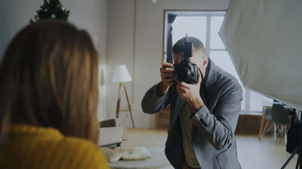 professional photographer taking portrait indoors