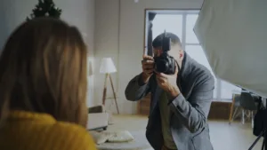 professional photographer taking portrait indoors
